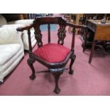 An XVIII Century Style Hardwood Corner Chair, with scroll hand rests and pierced splats on ball