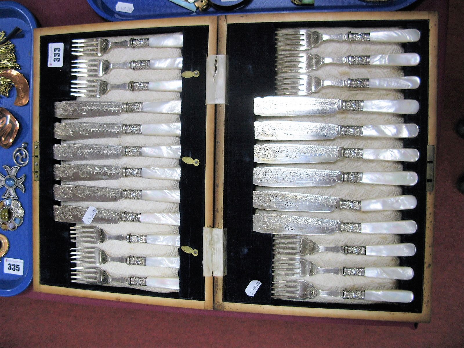 A Wooden Cased Set of Twelve Decorative Mother of Pearl Handled Fish Knives and Forks.