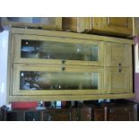 An Oak Display Cabinet, with glazed doors over cupboard doors, on square legs.