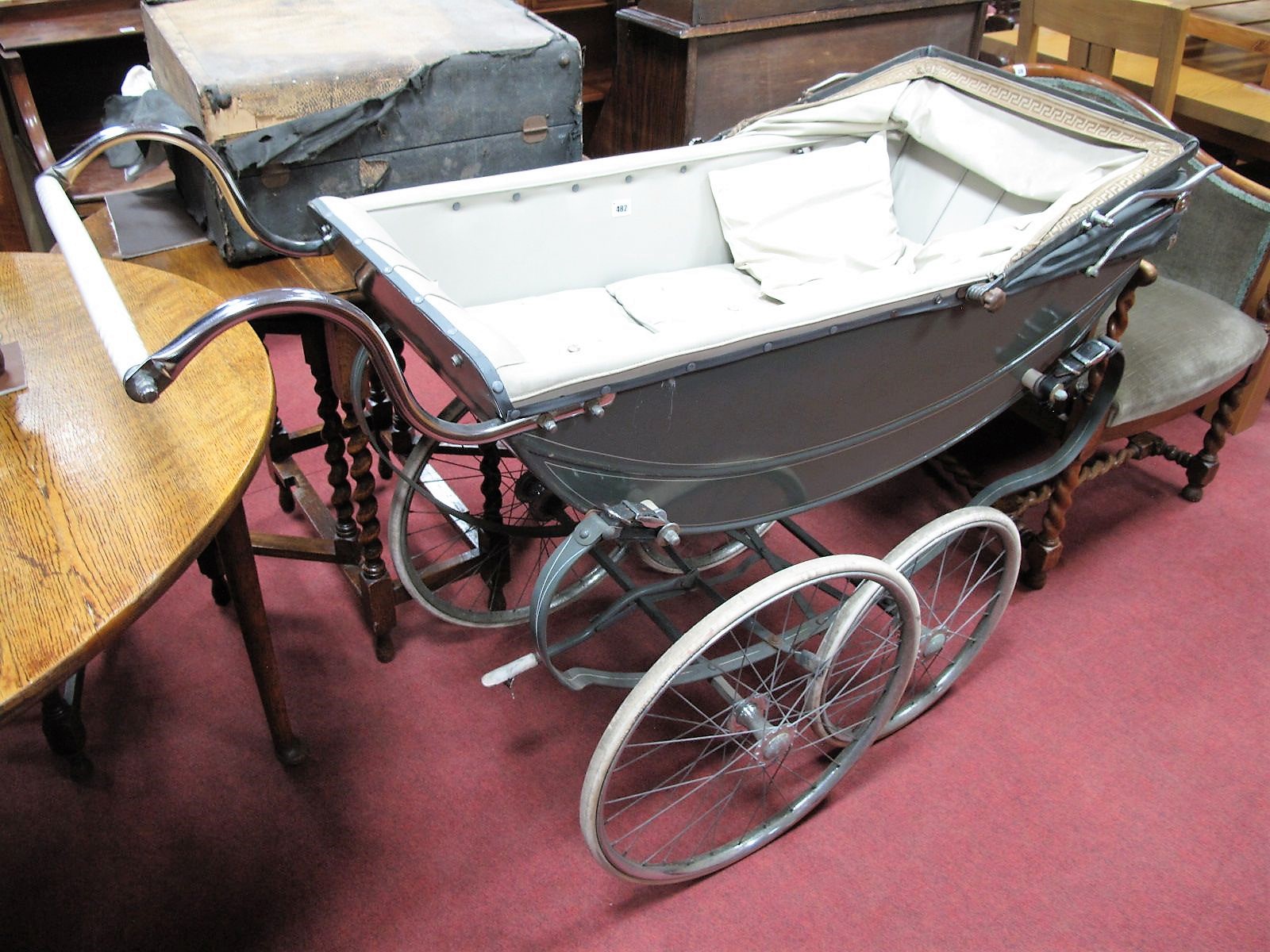 A Mid XX Century Manton Pram, disguised in the silver cross style.