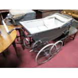 A Mid XX Century Manton Pram, disguised in the silver cross style.