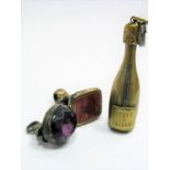 A Novelty Cigar Cutter, as a champagne bottle "Veuve Cliquot"; together with a hardstone inset