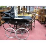 A Mid XX Century Silver Cross Pram, fitted with collapsable hood, head rest and body cover, in
