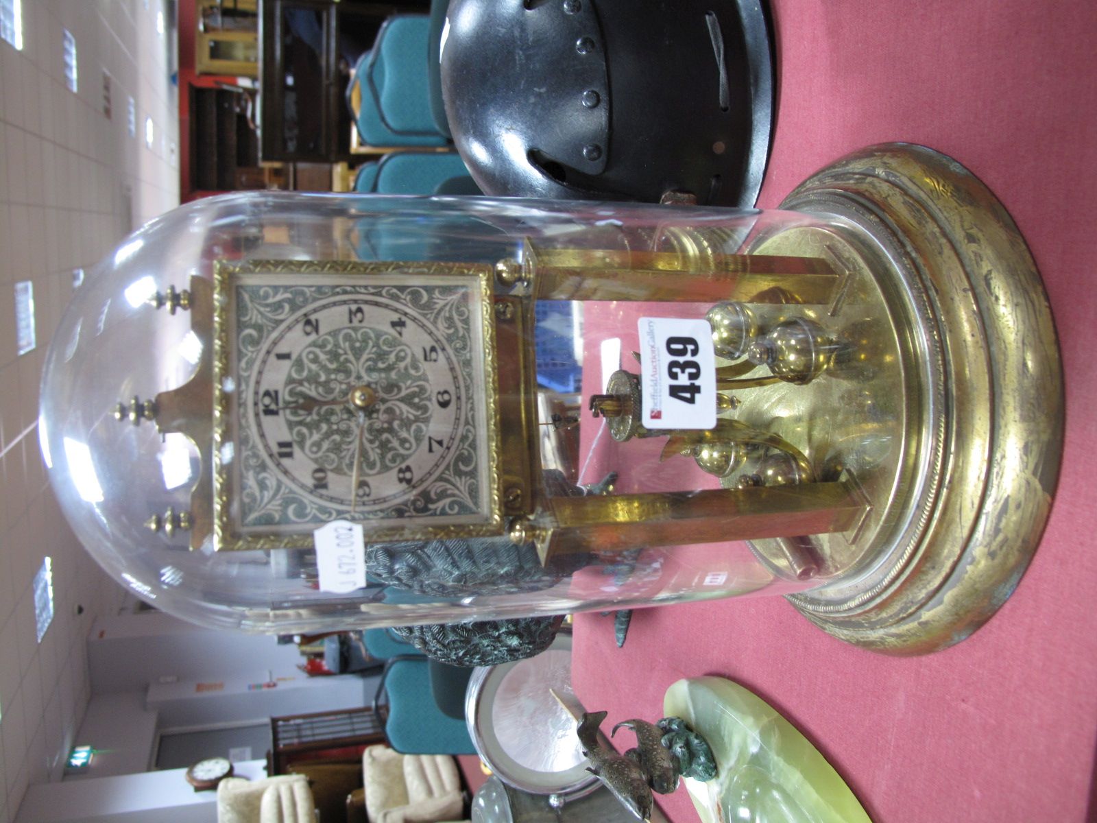 A Brass Skeleton Mantel Clock, stamped 20702 to back plate, on circular base, under dome.