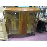 A Mid XX Century Walnut China Cabinet, with bow front centre panel, raised on squat cabriole legs.