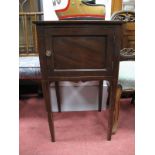 An Edwardian Mahogany Bedside Pot Cupboard, with a shaped low back and panelled cupboard door, on