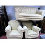 A 1920's Three Piece Lounge Suite, upholstered in a cream floral fabric, on bun feet.