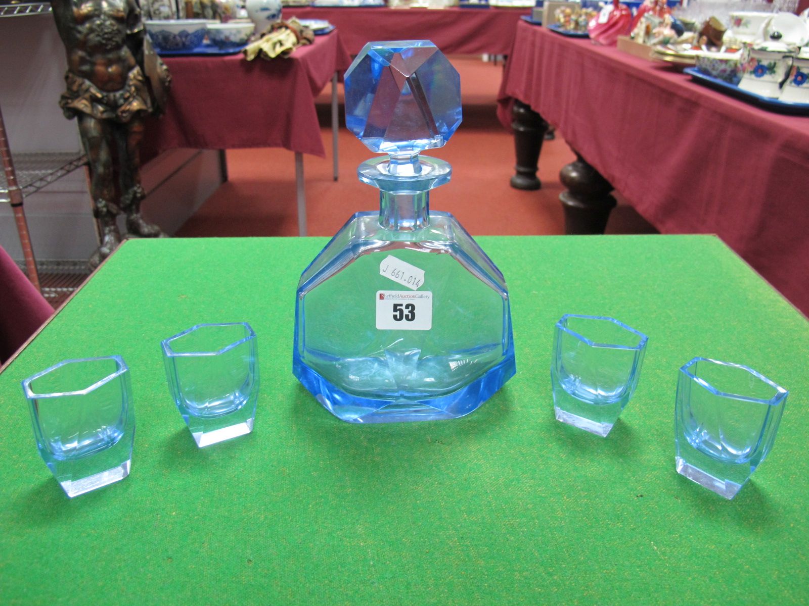 An Art Deco Blue Glass Faceted Hexagonal Decanter, and four matching tots.