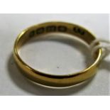A 22ct Gold Plain Wedding Band, Birmingham 1901, together with second hand purchase receipt dated