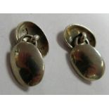 A Pair of Victorian Hallmarked Silver Cufflinks, the plain domed oval panels on figure of eight