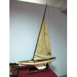 A Mid XX Century 'Tich' Wooden Pond Yacht, with rigging and cotton sails, length 93cm, mounted on