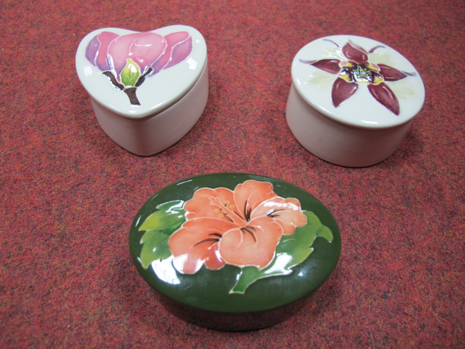 Three Modern Moorcroft Trinket Jars and Covers, including Magnolia, Columbine and Hibiscus,
