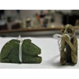 A Chinese Soapstone Carving of a Seated Monkey, its hands clasped 3.5cm high and a green hardstone