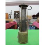 A Brass Framed Four Pillar Miner's Safety Lamp, with exposed gauze and suspension hook.