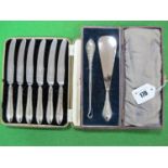 A Cased Set of Six Hallmarked Silver Tea Knives, together with a matching shoe horn and button hook.