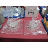 A Pair of Moulded Glass Model Swans, each resting on shaped square stands.