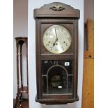 A 1940's Oak Wall Clock, with a silvered dial.