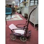 A Circa 1950's Vintage Baby's Pushchair, in maroon.