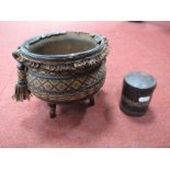 A Cast Iron Three Footed Cauldron, leather clad with tassels and geometric bands, diameter 16cm, and