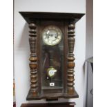 A XIX Century Vienna Style Wall Clock, with a stepped pediment, enamel dial, turned pilasters.