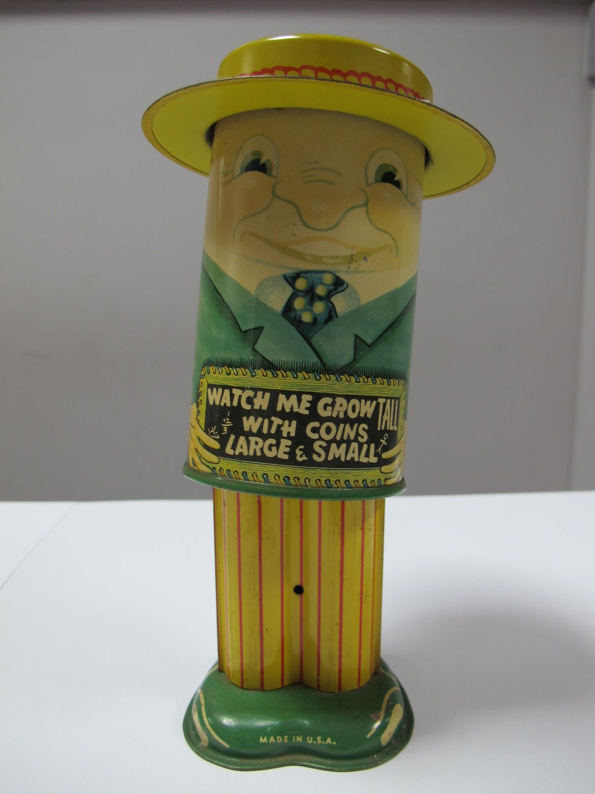 A Mid XX Century Tinlate Money Box by Apex of America, a spring loaded action in the form of a