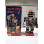 An Original Tinplate and Plastic 'Fighting Robot', with sound, lights, fire gun, swinging arms,