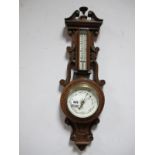 An Early XX Century Oak Aneroid Two Dial Barometer, with a broken pediment, decorated C and S