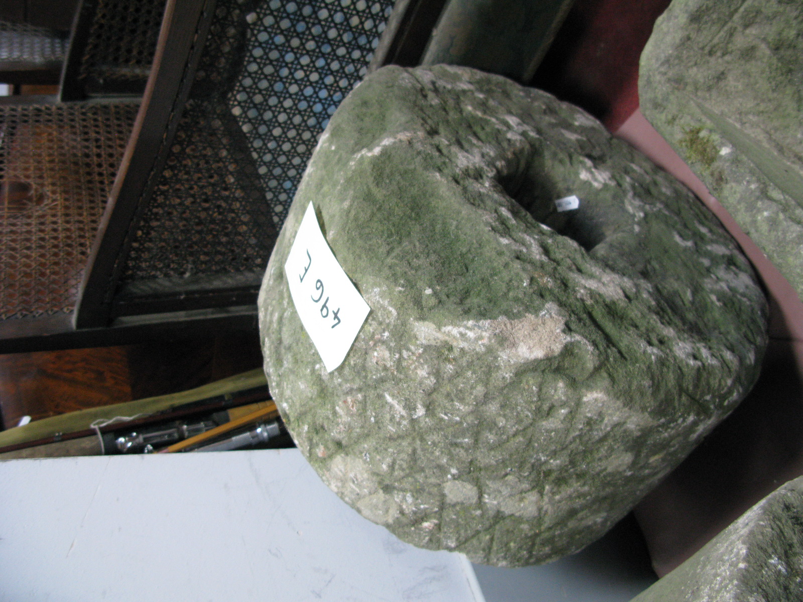 A Stone Grinding Wheel, having square open centre. Approximately 46cm diameter overall.