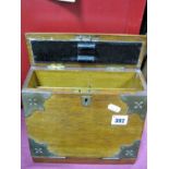 An Early XX Century Oak Stationery Box, hinged lid with brass shield mount, fall front, fitted