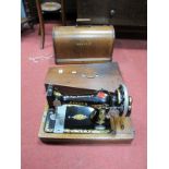 A Singer Sewing Machine, in oak dome case, together with a XIX Century mahogany quadrilateral box.