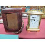 A French R & Co. Brass Cased Carriage Clock, with carrying handle, 10cm high, in a maroon leather