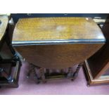 A 1920's Oak Barley Twist Gateleg Table, with drop leaf oval top.