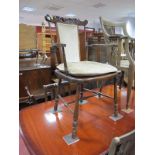 An Early XX Century Stained Beech Bedroom Chair, with carved floral cresting and spindle supports.