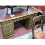 An Early XX Century Mahogany Pedestal Desk, with a cross banded top, moulded edge, leather