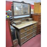 An Early XX Century Oak Dressing Table, with a rectangular central mirror, two jewel drawers,