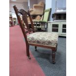 A Late Victorian Mahogany Nursing Chair, arched and foliate carved cresting rail, reeded supports,