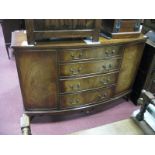 A Reprodux Mahogany Bow Front Sideboard, with four graduated drawers, flanked by cupboards on