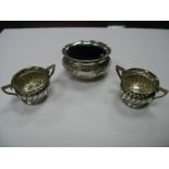 A Pair of Victorian Hallmarked Silver Salts, each of spirally reeded twin handled form, with clear