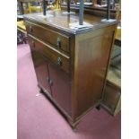 A 1920's Oak Cabinet, with a low back, two long drawers over cupboard doors, on cabriole legs.