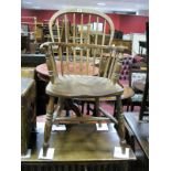 A XIX Century Ash and Elm Windsor Chair, with a hooped back, rail supports, on turned legs, united