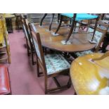 An 'Old Charm' Oak Dining Table, with an oval top, on turned and block supports, united by X