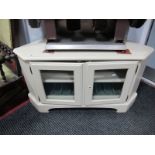 A Painted Corner TV Stand, with glazed doors, bracket feet.