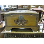 A XX Century Carved Camphor Wood Blanket Box, with a domed top, carved scenes, on bracket feet.