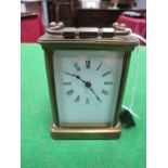 An Early XX Century French Carriage Clock, with carrying handle and enamel dial with Roman numerals.