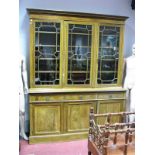 An Edwardian Inlaid Mahogany Three Door Bookcase, with a stepped cornice, three astragal doors, base