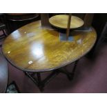 A 1920's Oak Drop Leaf Table, with an oval top, moulded edge, on bobbin turned legs.