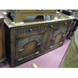 A XVII Century Style Oak Dresser Base, with three top drawers, knulled decoration over arch panel