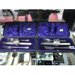 Two Cased Christening Sets, each with hallmarked silver napkin ring, in original fitted case. (2)