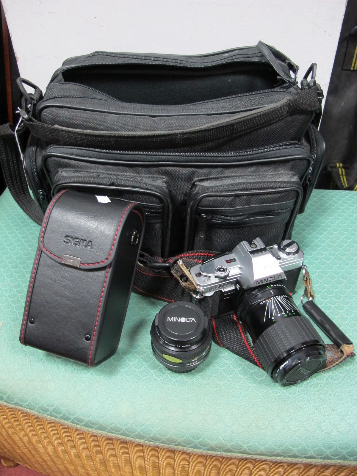A Cased Minolta X-300 35mm Film Camera, Minolta MD 50mm F1.7 lens, Sigma 35-70mm F2.8-4 lens,
