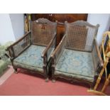 A Pair of Early XX Century Bergère Armchairs, with cained back and arms, and shaped and reeded